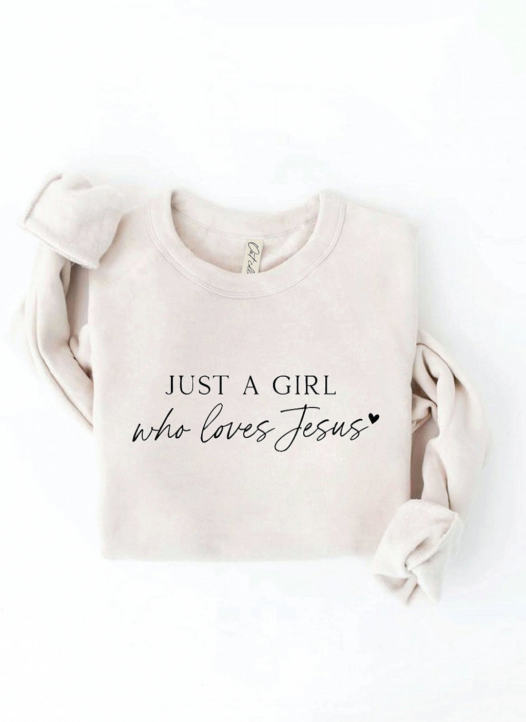Beige sweatshirt with 'Just a Girl who loves Jesus' text on a white background. Oat Collective, super soft.
